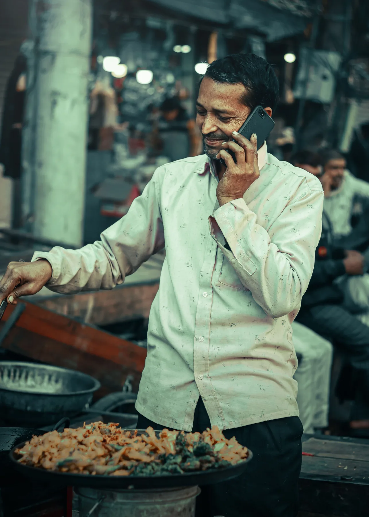 Food vendor using a phone, representing direct product enquiries